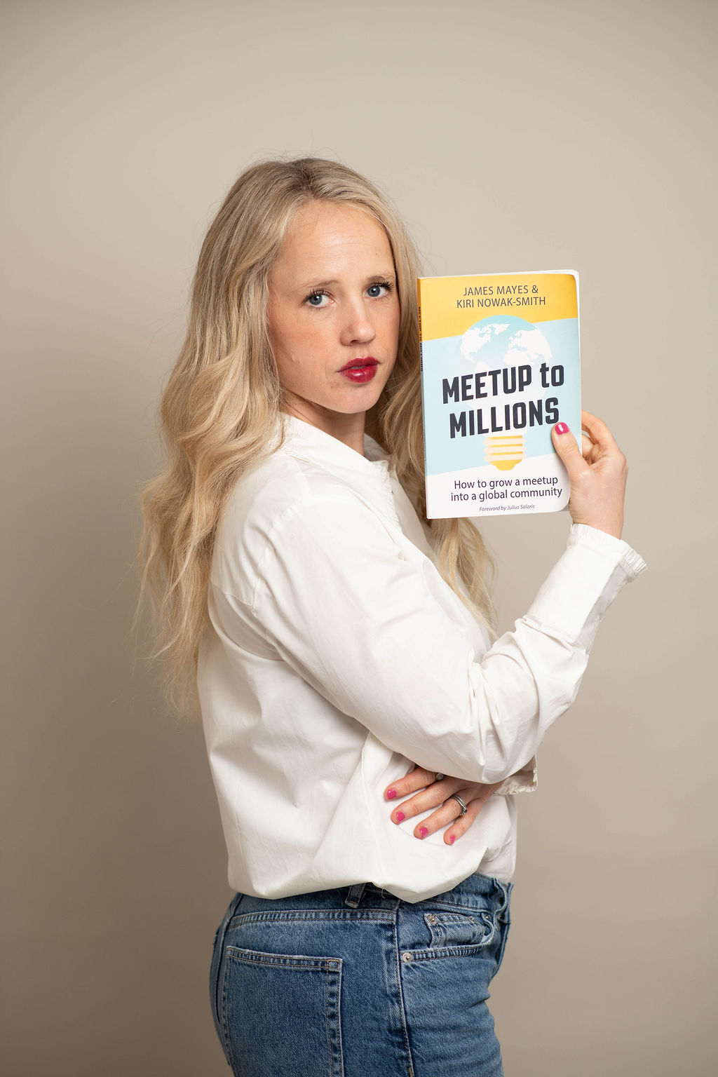 Kiri holding her book, Meetup to Millions