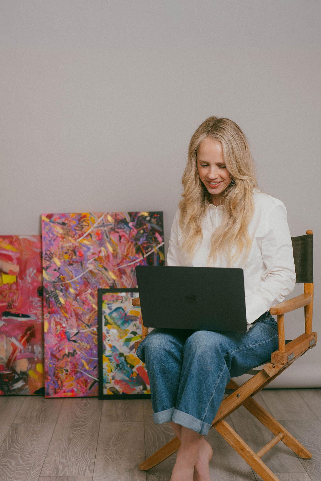 Kiri writing on her laptop in the studio